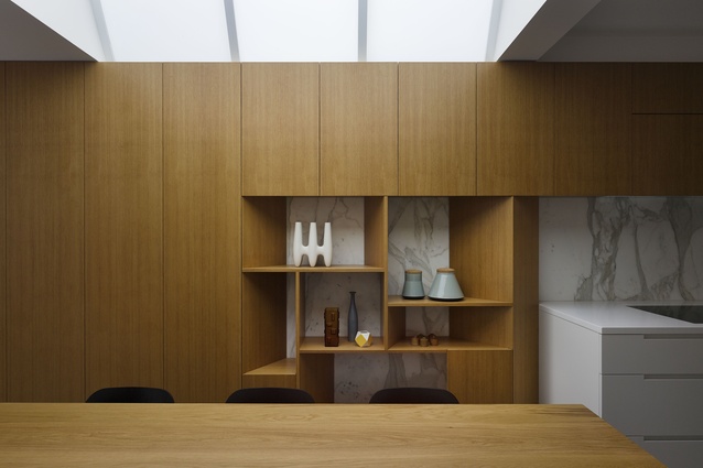 The timber joinery element defines space, hides services and provides display space.