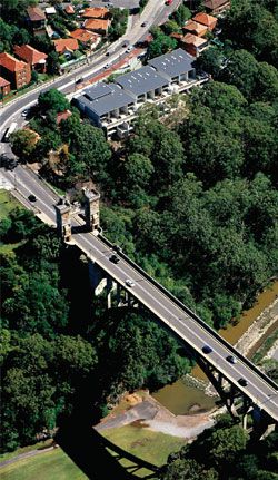 Aerial view showing the eighteen-unit development with the Cammeray Bridge in the foreground.