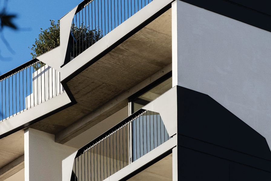 The solid off-form concrete and lightweight angular balustrades of 41 Birmingham create a striking impression from the street.