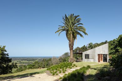 From the forest the house presents as a simple, silvery grey trapezoid, its a roofline in tune with the tumbling slope.