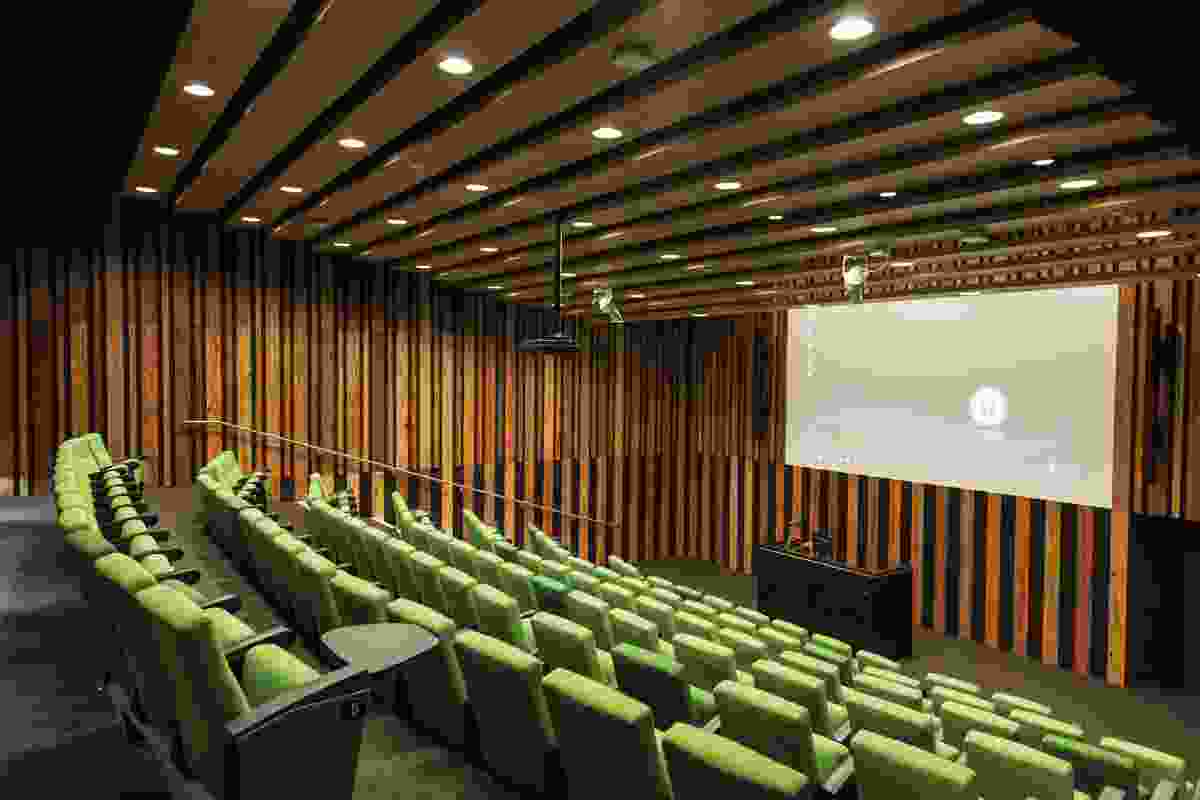 The vivid green and timber tones in the ground-floor theatre provide welcome respite from the stark white interior of the laboratories.