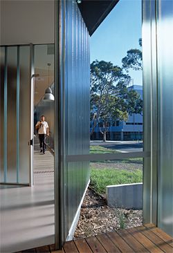 A sheet of clear glass looks south as the glass plank wall kinks inwards.