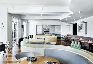 Referencing the geometry of the late Art Deco period, the S-shaped banquette helps zone the large open dining space, giving patrons a variety of seating options as well as privacy.