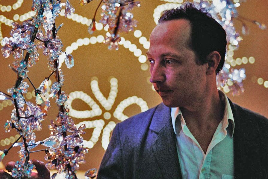Tord Boontje with his chandelier designed for Swarovski, Blossom.