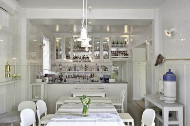 The downstairs kitchen is casual in all white.