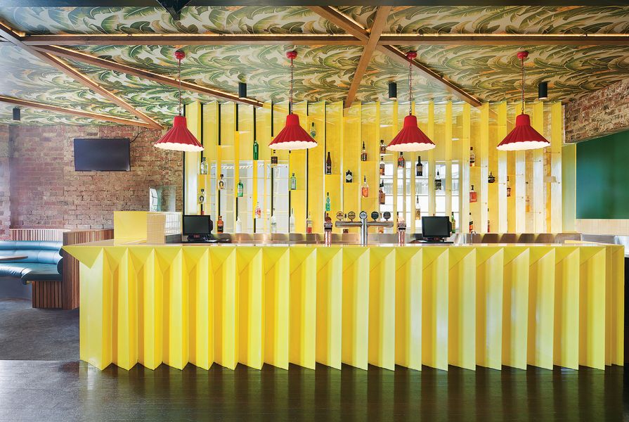 Beneath banana plant print wallpaper, another upstairs bar has painted steel Barfront and joinery detailing.