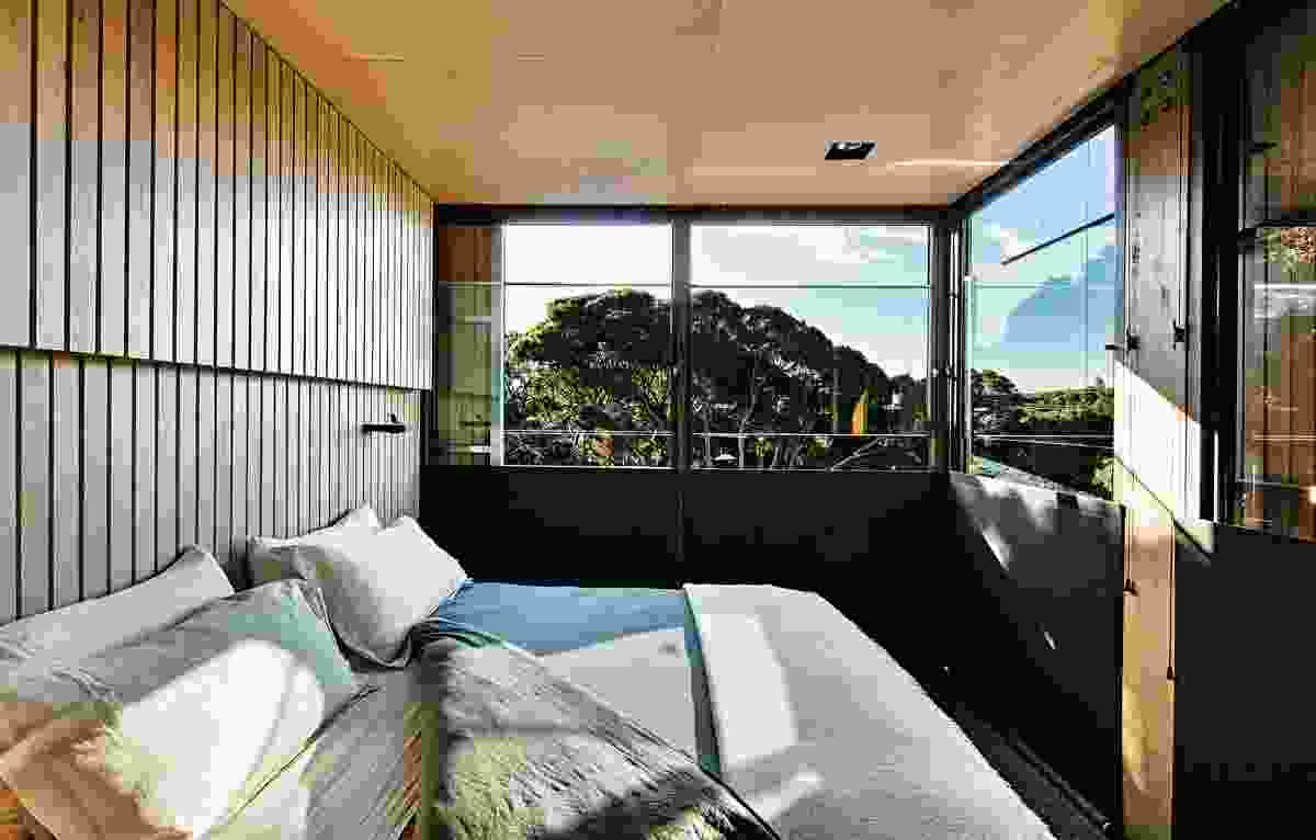 The loft bedroom floats above the living area and enjoys a leafy outlook.