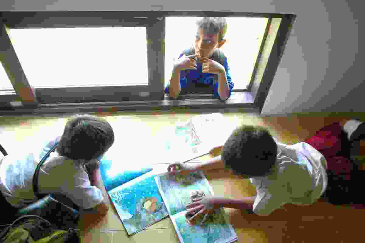 Schoolchildren at work in Terrain Architects' library in Java, Indonesia.
