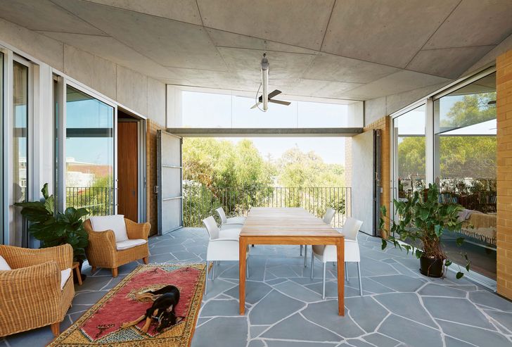 Large bi-fold doors open to give the central terrace views of the replanted verge and the street beyond.