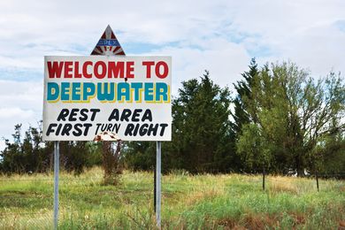 This photograph at Deepwater in the Northern Tablelands shows a sign that lures tired motorists with the promise of a rest area ahead.