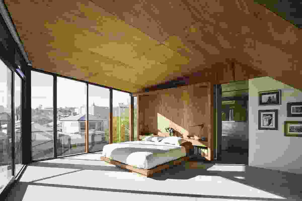 The main bedroom’s timber-lined ceiling follows the external roof form.