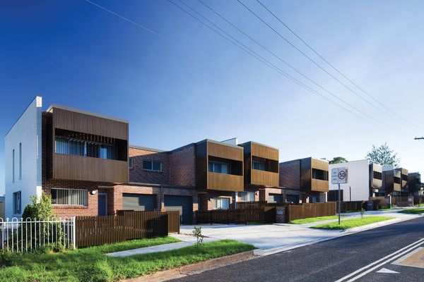 The project combines two-storey townhouses fronting Hope Street with single-storey villas accessed via a side street.