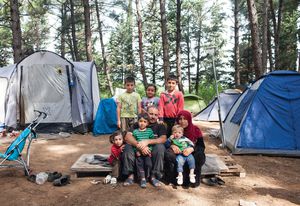 Abdisalam and his wife Rauha with their six children in a forest camp near the BP service station refugee camp of Evzoni, Greece. They left their home in Deir ez-Zor, Syria, in September 2012, and after spending years in Lebanon and Turkey they arrived in Greece two months before this photo was taken.