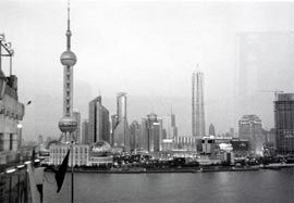 Shanghai context.
View across the Huangpu river towards the Pudong New Area (special economic zone), at night. The tallest building is the Oriental Pearl broadcasting and television tower. Photograph John Gollings.