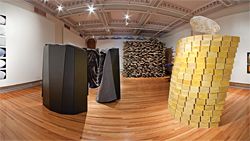 An overview of the Shelter: On Kindness exhibition at RMIT Gallery. On the left is LAB Architecture Studio’s Safe-House. To the right is Gregory Burgess and Pip Stokes’ yellow beeswax installation, Sense. March Studio’s shelter is seen in the background.