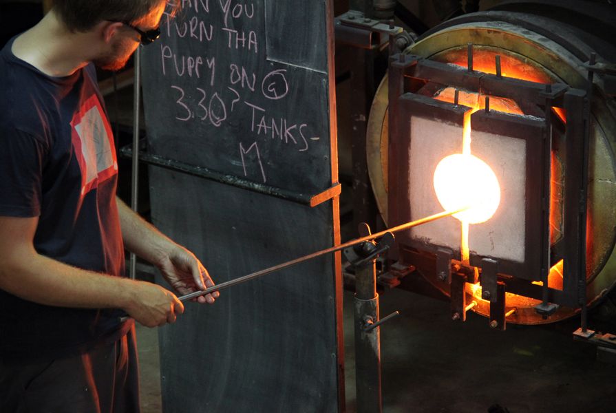 In the Glass Studio, the molten form goes back into the furnace.