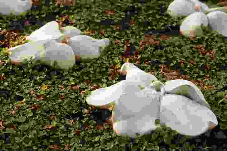 The white concrete flowers are shaped like violets, a symbol of remembrance.