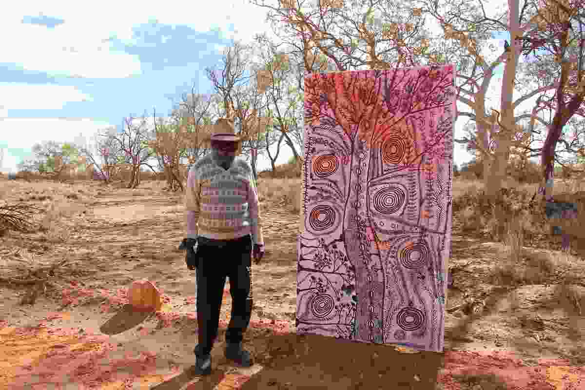Peter Mungkuri OAM with his work 'Punu' (Trees), 2020.