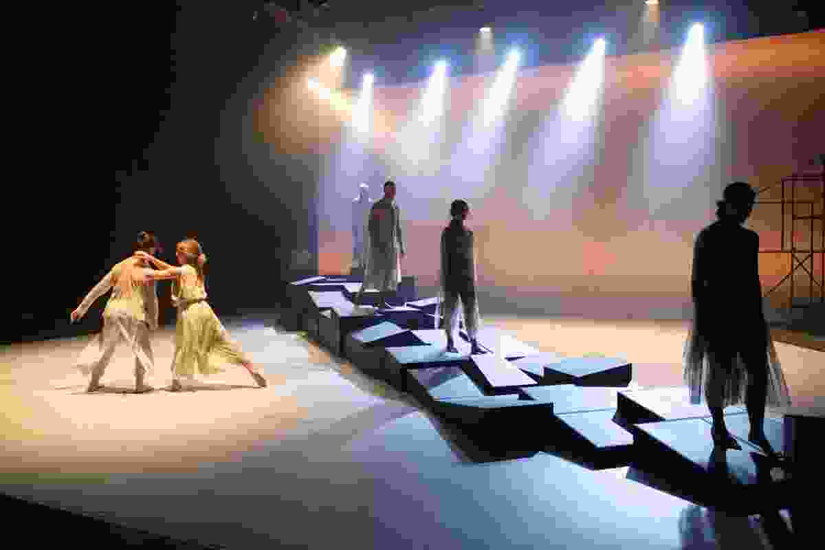 The dancers create various terrains with the modular components of the wall.