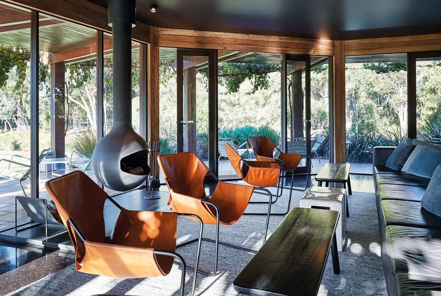 Overlooking the vineyard, the wine lounge is furnished with a comfortable leather lounge, leather-slung armchairs, ceramic side tables and blackened oak tables.