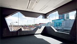 View north from office space on the third floor. The angularity of the windows is determined by the patterning of the exterior walls.