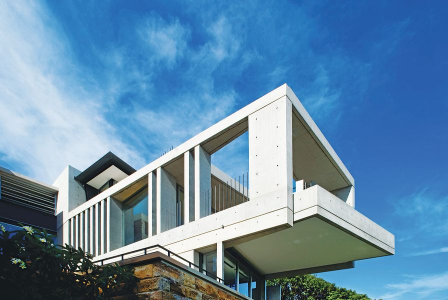 The dramatic cantilever hangs out over a swimming pool.