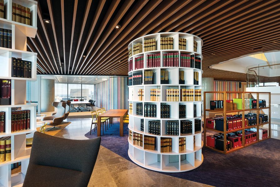 The colourful staff level has walls upholstered in missoni fabric and shelves of books.