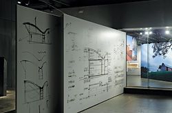 Drawings of the Bingie Point House, looking through the exhibition window towards an image of the Marie Short House.