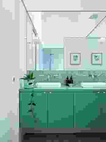 Easy-to-maintain bathroom surfaces in soothing colours evoke the nearby ocean. Artwork: Frances Luke.