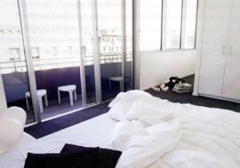 A bedroom on the south end of the building, with a concrete
balcony overlooking Collins Street.