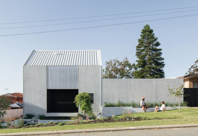 House A sits close to the site’s front boundary, presenting a near-blank concrete facade to the street.