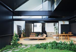 The new living and kitchen spaces are connected to the existing cottage by a half-height staircase that leads from the original hallway.