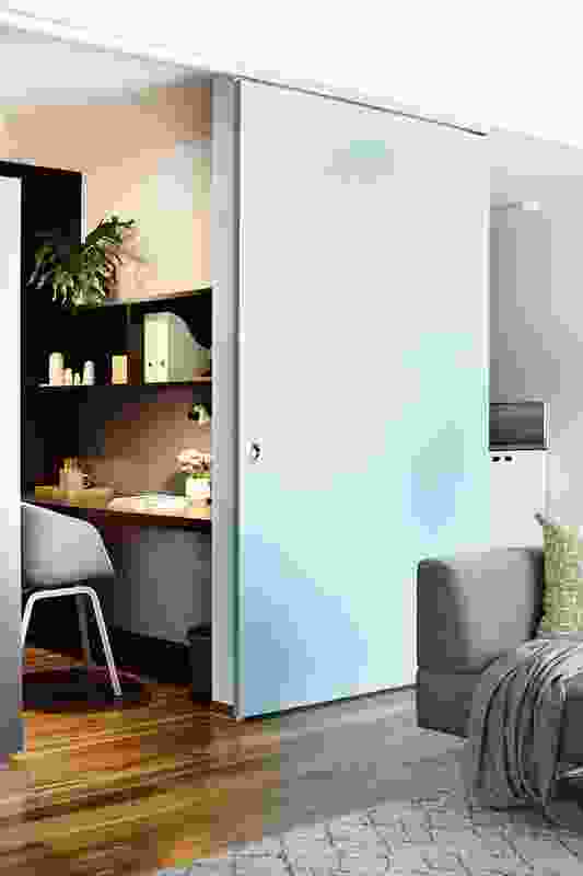 A study alcove can be visually separated from the living room by a coloured sliding panel.