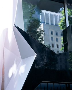 Details of the building facade showing the contrast between black and white surfaces.