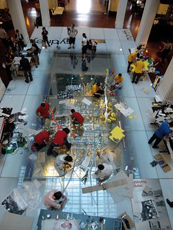 The public were encouraged to wander among the five competing teams at Customs House. The Sydney City model is seen under the glass floor.