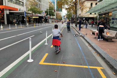 Along Queen Street in central Auckland during the COVID-19 lock-downs, emergency measures reallocated space for walking, cycling and scooting.