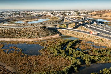 The freeway runs through a landscape of mangroves and intertidal samphire ecologies, disturbed over the years by industrial and horticultural activities.