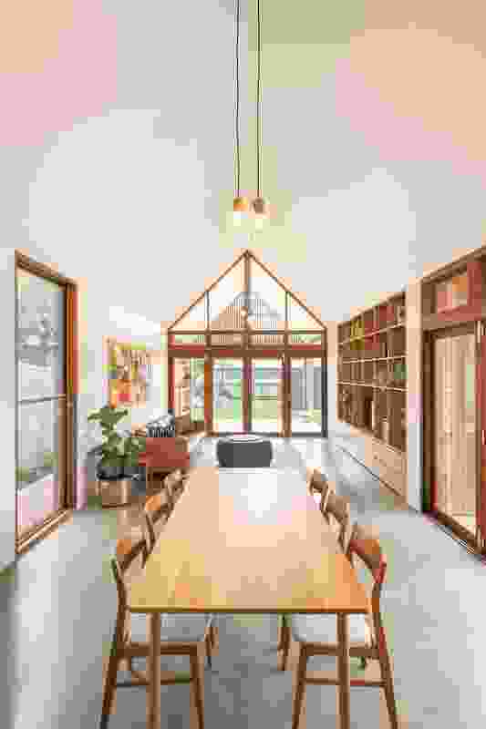 The extension’s gable roof is used to maximum effect in the dining and living areas, where the ceiling height reaches a generous five metres. Artwork: Hanako Clulow.

