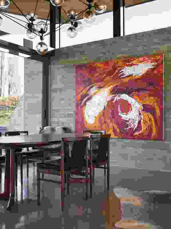 Artwork provides a splash of warm colour in the dining room.