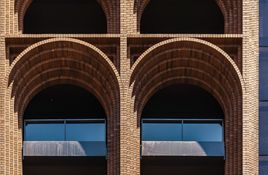 A series of arches adorn the façade of the Arc building.