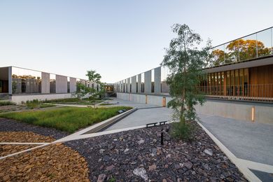 Triangular geometries and concrete walls retain layers of rocky shale.