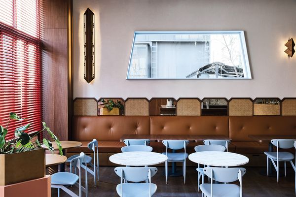Brass accents, buttery caramel leather banquettes and the use of the Featherston Scape dining chair, an Australian mid-century classic, hint at 1950s Italian spaces.