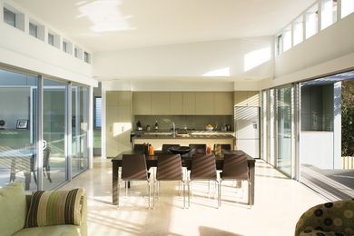 The living room, between verandah and courtyard, is cross-ventilated and naturally lit. Operable clerestory windows expel the hot air.