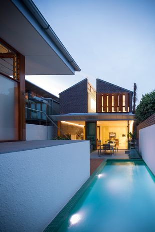 An elegant pavilion like studio presides over the rear laneway adjacent the pool