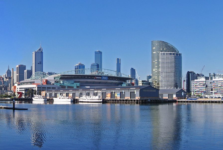 A panoramic view of Docklands and the Melbourne City Skyline taken from Waterfront City, looking across Victoria Harbour. Melbourne, Victoria, Australia.
Features include (from left), some commercial and residential buildings along the harbour at New Quay, the Seven Network digital broadcast centre, the Telstra Dome (Docklands Stadium), some of the original (now renovated) Melbourne docks sheds on Central Pier, and commercial buildings, including the colourful lowrise National Australia Bank headquarters.
In the background is the Melbourne CBD skyline, including the Rialto Towers (the tallest office building in the Southern Hemisphere) and the Eureka Tower (the tallest residential building in the world). The construction in progress of some buildings in Docklands shows the still evolving nature of this part of the city.  by Jjron, licensed under  CC BY-SA 3.0 