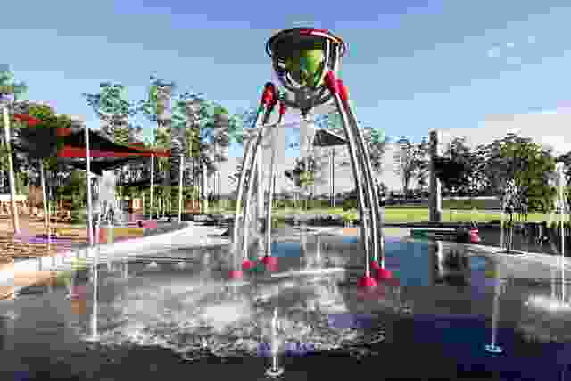 The waterpark, with its central waterfall, is a popular destination for children.