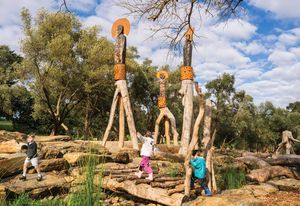 Sculptures created by artists Karl Winda Telfer and Tikana Telfer from upturned trees ringed with weathered steel bands offer both ornament and story.