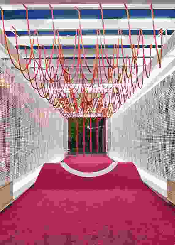 Netted walls and hanging ropes invite visitors to participate and engage with the pavilion.