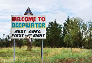 This photograph at Deepwater in the Northern Tablelands shows a sign that lures tired motorists with the promise of a rest area ahead.