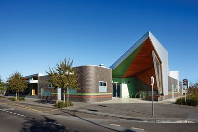 Opposing lines: a curved brick wall offsets the sharply angular roof.